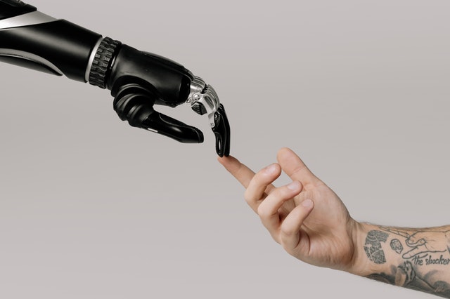 Robotic prosthesis touches a human hand, biotech